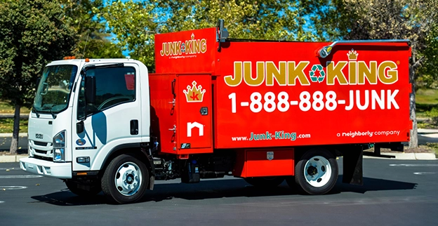 Red Junk King branded dump truck.