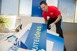 Junk King professional removing signage from a building.