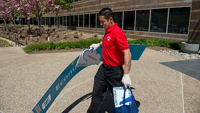 A Junk King professional carrying retail signs.