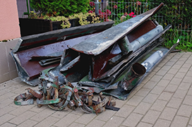 Scrap metal pile in front of a building.