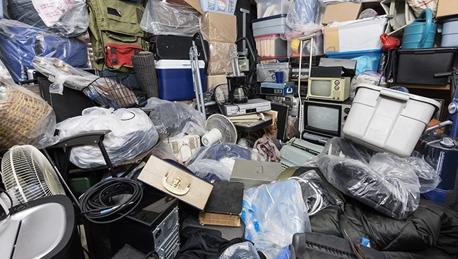 A room full of miscellaneous junk, including boxes, totes and old electronics.