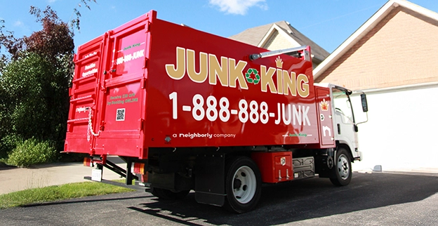 Red dump truck parked in front of a home.