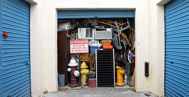 An open storage unit full of junk.