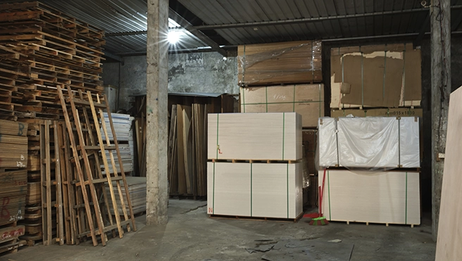 An old warehouse with pallets stacked against the wall.