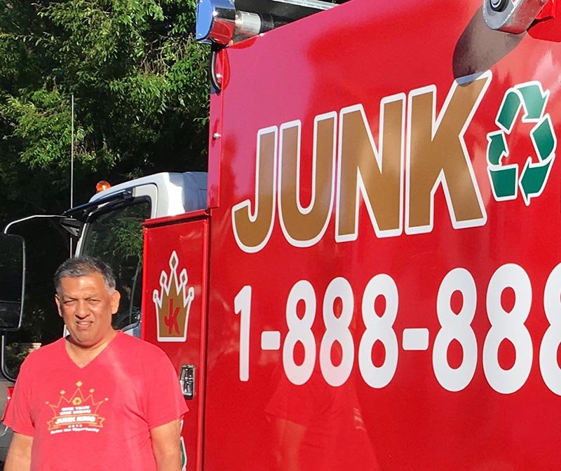 Junk king worer alongside junk king truck