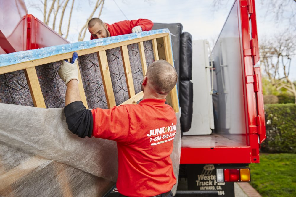 junk king workmen loading household items to truck