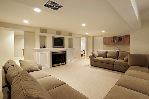 modern home theatre furnished with a grey sofa and flat screen TV