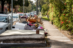old matress and furniture outside on curb