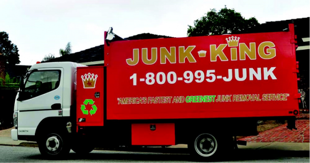 Red Junk King Truck parked in front home