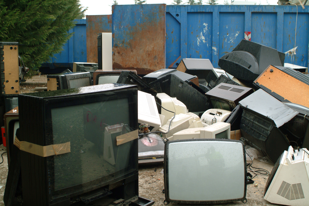 Appliance disposal yard filled with old Tv's and appliances 