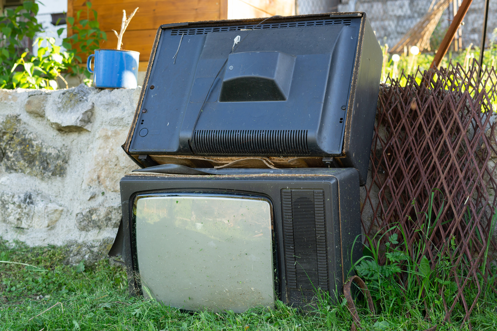 2 old TVs waiting for disposal 