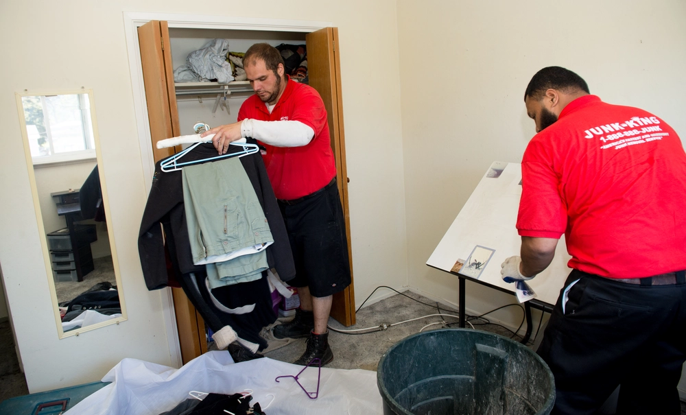 Junk King crew performing a full home cleanout, removing furniture and household items