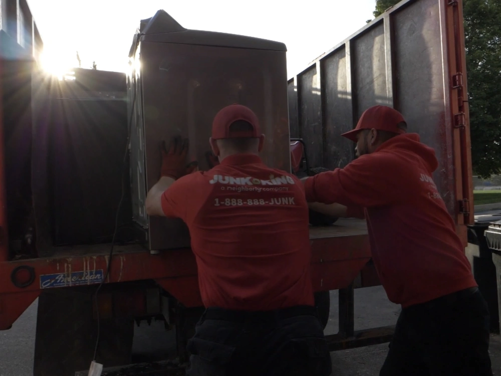 Junk King team hauling away old appliances in Half Moon Bay