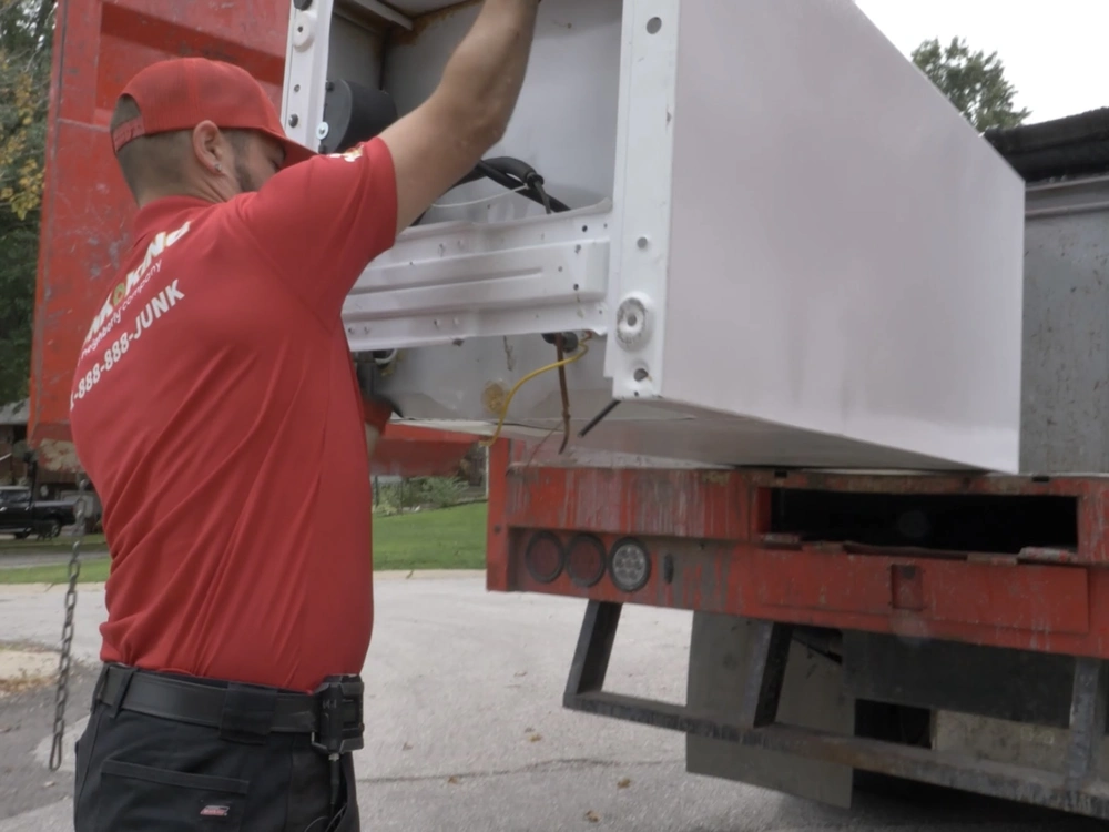 Atherton team removing an old refrigerator