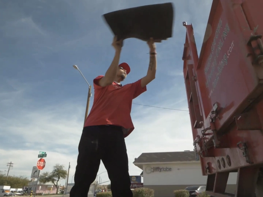 Team loading junk onto a truck in El Granada