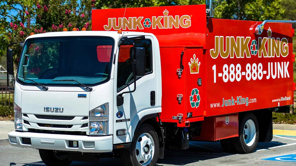 Junk King red truck and crew ready for full-service junk removal