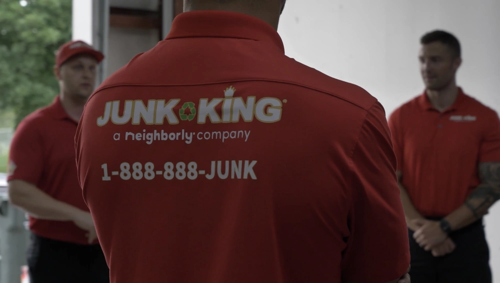 Junk King team removing an old hot tub from a backyard in San Carlos