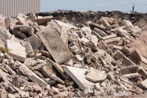 A large pile of rubble next to a building.
