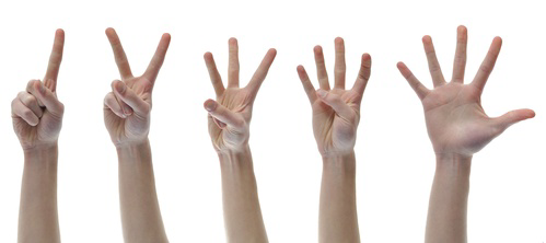 A group of hands holding up their fingers.