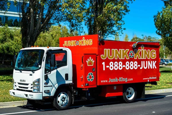 A junk truck parked on the roadside.
