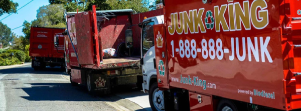 Row Junk King trucks parked on a residential street.