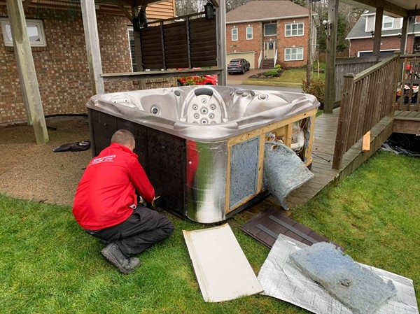 A man is repairing a hot tub.